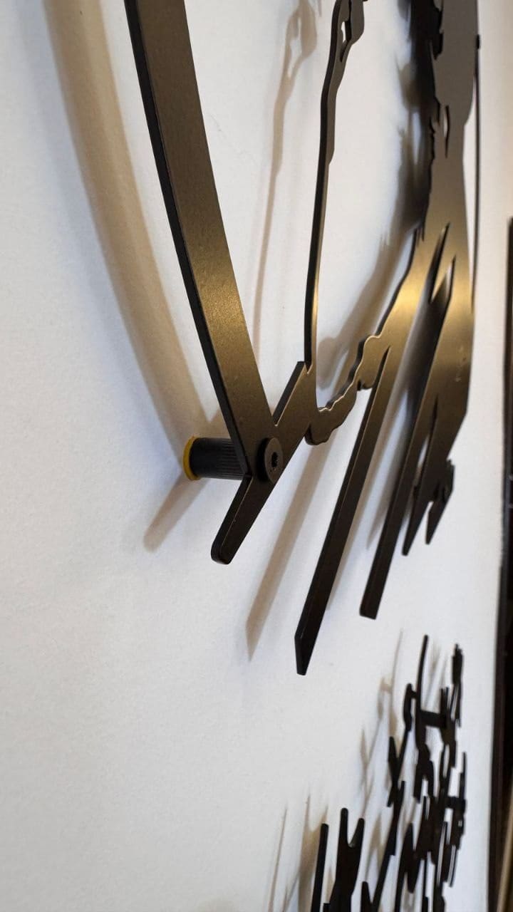 Close-up of a laser-cut steel piece standing off the wall