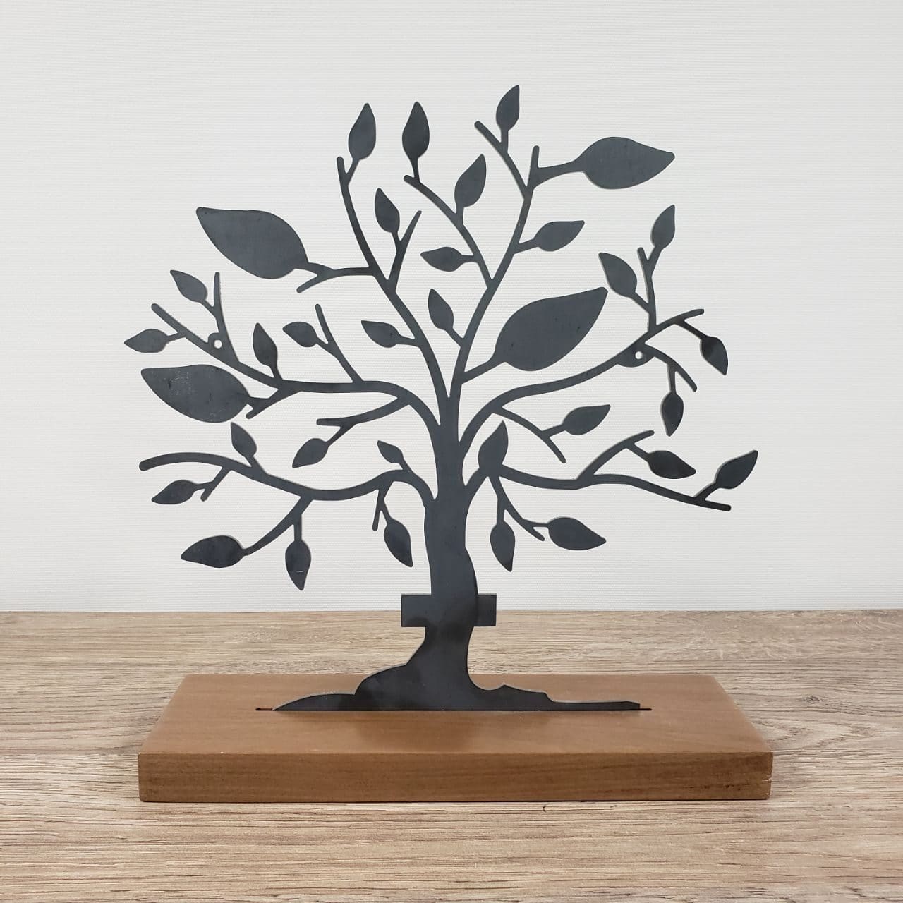 A laser-cut AWTAD steel tree on a walnut base